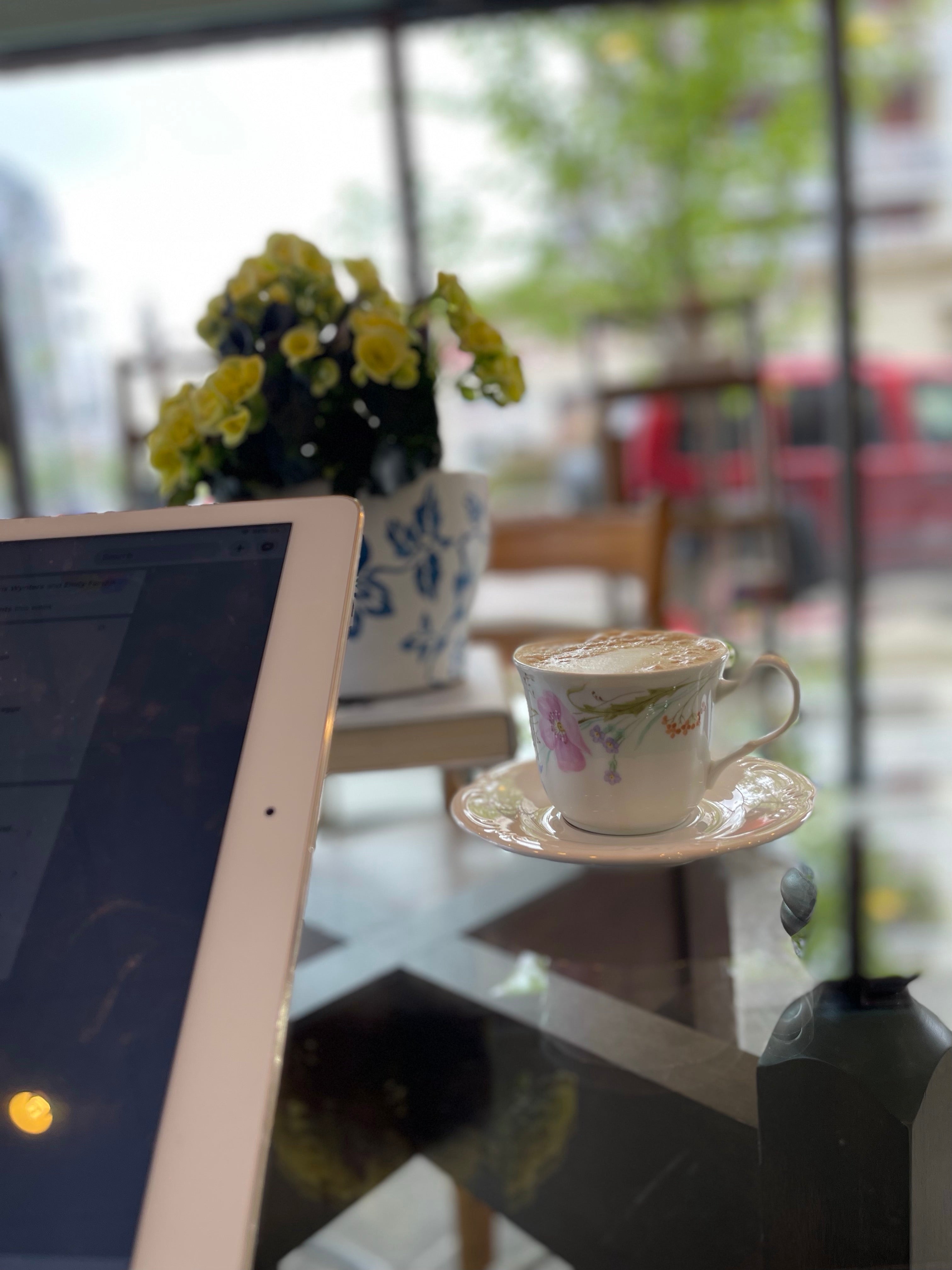 Vintage tea cup with tablet on table at the Cove Tea Co.